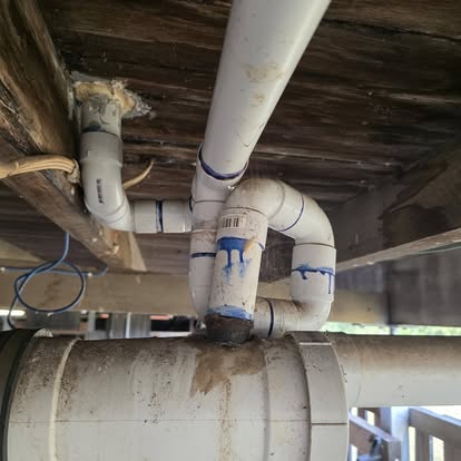 Close-up of underfloor pipework and timber framing